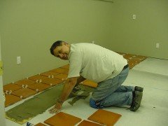 The walls were painted, now Jerry is installing the saltillo tile floor